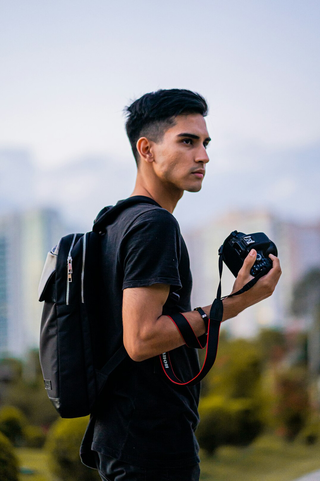 Photographer holding a professional camera outdoors