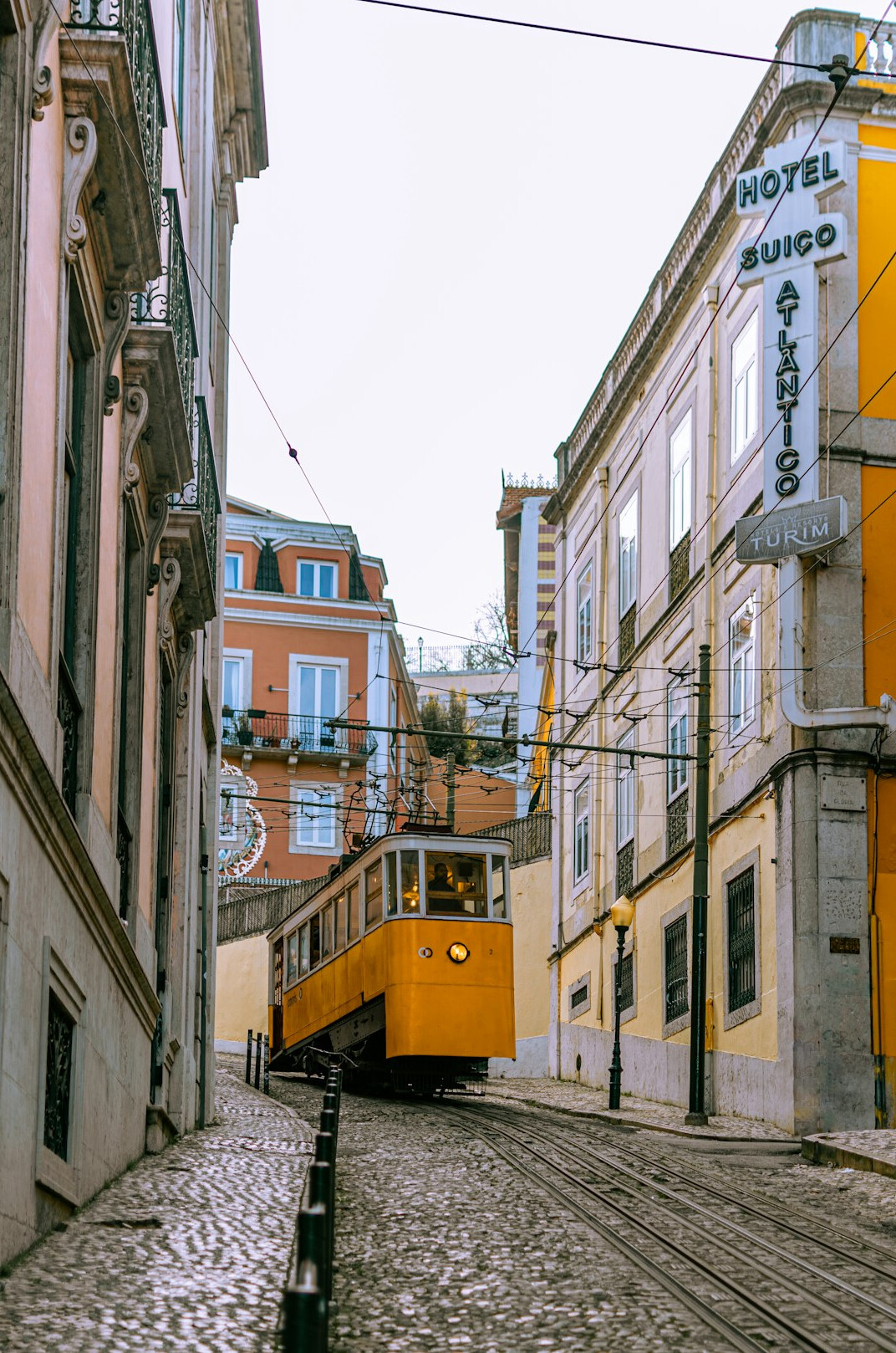 Yellow tram on a street in Lisbon